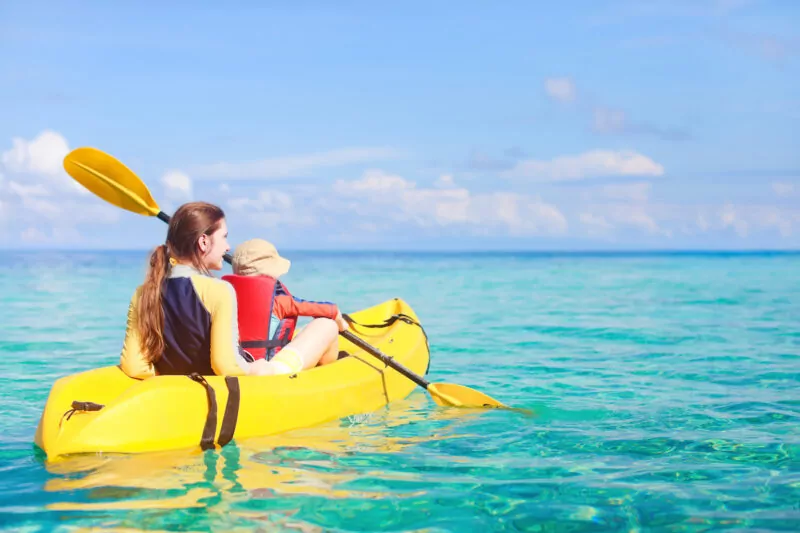 Mother and son kayaking in the ocean